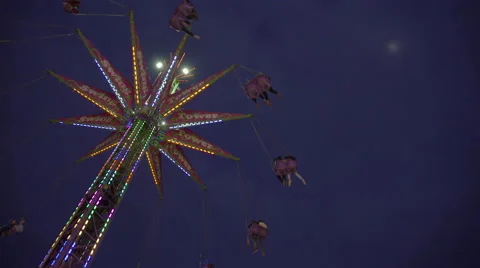 Swing tower ride at amusement park on a cloudy early evening. 4K UHD. Stock-Footage 54317147