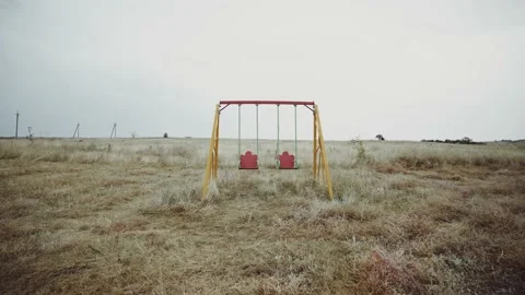 Swing without children. Swing in an abandoned place. Abandoned playground. Stock-Footage 165741470