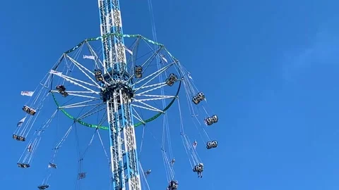Swinging carousel, flying seats at an amusement park fair, aerial ride Stock Footage 286238371