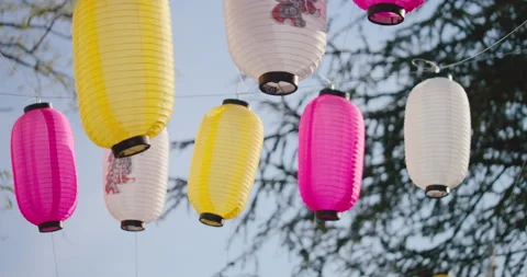 Swinging chinese lanterns hung by a thread in the sky. Lanterns of many Stock Footage