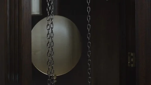 A swinging clock pendulum in SLOW MOTION. Stock Footage 122009857