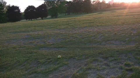 Swinging at driving range in setting sun Stock Footage 666901