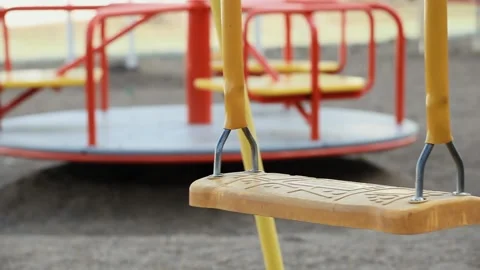 Swinging Empty Childrens Swing in the Playground. Concept of Childhood Stock Footage 154048086