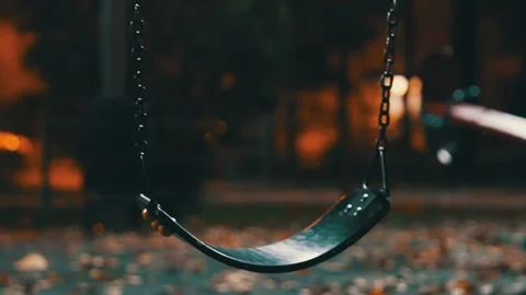 Swinging Empty Playground Swing Attached to Metal Chains at Dusk. Play Area Stock Footage 321555407
