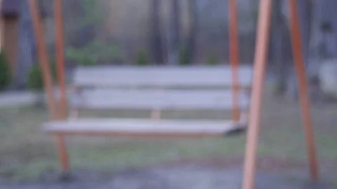 Swinging empty swing in the park Stock Footage 74065628