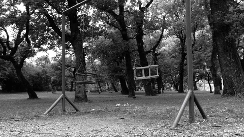 Swinging empty swings at the park Stock Footage 89914289