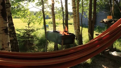 Swinging Hammock on Background of Summer Nature and Fire Stock Footage 137630993