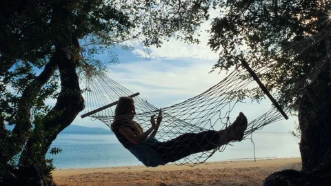 Swinging in a hammock Stock Footage 129321895