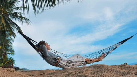 Swinging in a hammock Stock Footage 129322116