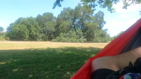 Swinging on a hammock on the park Stockbeeldmateriaal 156133535