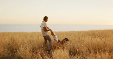 Swinging his son into the sunset Stock Footage 101398441