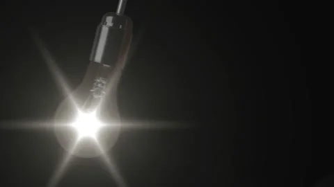 Swinging light bulb a black background Stock Footage 86022489