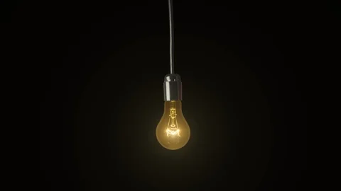 Swinging light bulb a black background Stock Footage 86288595