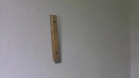 Swinging Object on Empty Wall – Minimal Cinematic Horror Scene Stock Footage 327440268