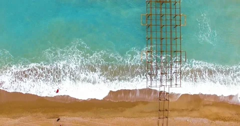 Swinging Over the Waves and Sandy Beach Top Drone Shot Stock Footage 149858651