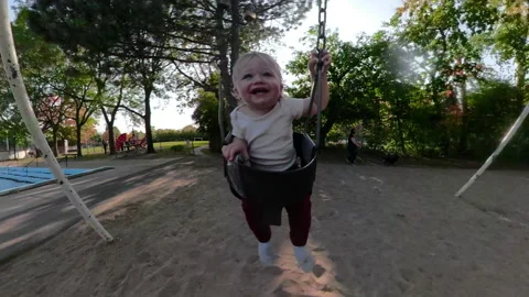 Swinging at the park with daddy - child playing Stock Footage 140364028