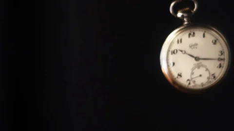 swinging pocket watch against black Stock Video Pond5