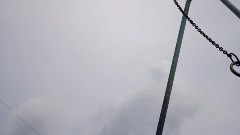 Swinging rings suspended from a playground structure, captured in a dynamic Stock-Footage 321054035