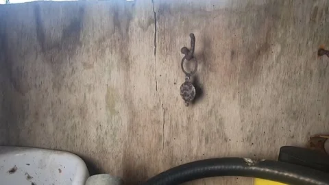 Swinging, rusty pendant on hook Video stock 332560666