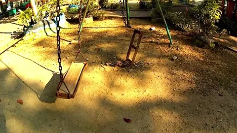 Swings on a playground in a park Vídeos de archivo 333281871