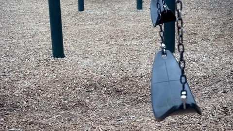 Swings Swinging on a Playground Stock Footage 79331824