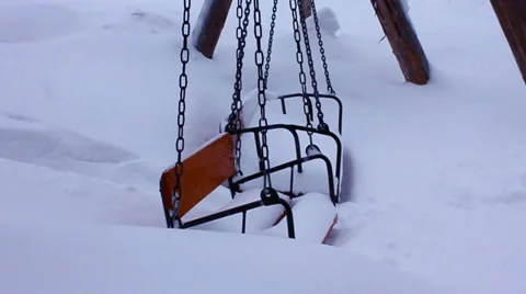 Swings under the snow Stock Footage 32460342