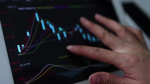 Swipe the mobile phone and flat screen to browse the stock market trend Stock Footage 198990270