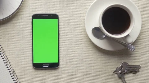 Swipe touch gestures on a cell phone with a large green screen at a cafe Stock Footage 75458142