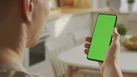 Swiping Right Twice. Back View of Man at Phone with Green Screen for Copy Space Stock Footage 171139708