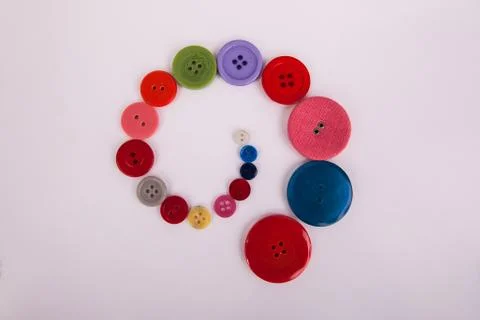 Swirl pattern made of buttons assorted sizes and colors Stock Photos