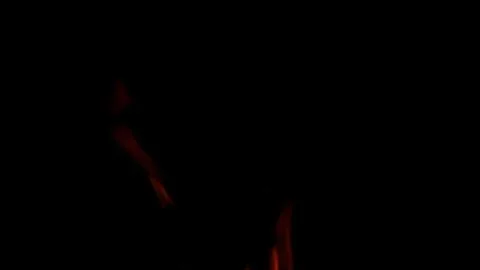 The swirling and dancing flames set against a dark background create a captivati 写真素材