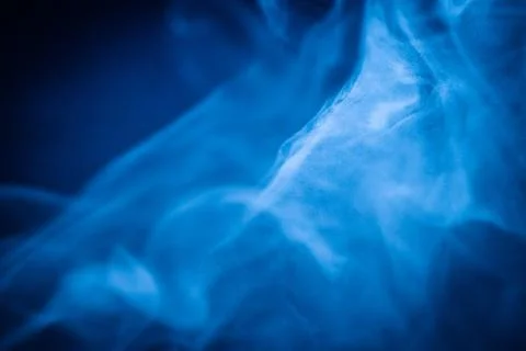 Swirling blue smoke patterns creating an ethereal and dreamy abstract effect Stock Photos