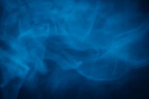 Swirling blue smoke patterns creating an ethereal and dreamy abstract effect Stock Photos