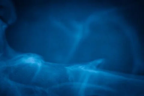 Swirling blue smoke patterns creating an ethereal and dreamy abstract effect Stock Photos