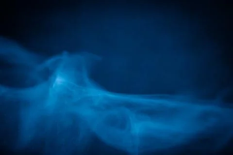 Swirling blue smoke patterns creating an ethereal and dreamy abstract effect Stock Photos
