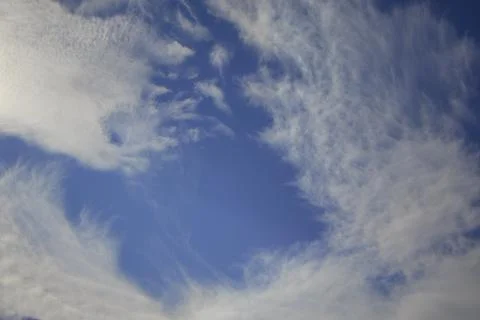 Swirling Cirrus Clouds Forming a Dramatic Pattern in the Sky Stock Photos