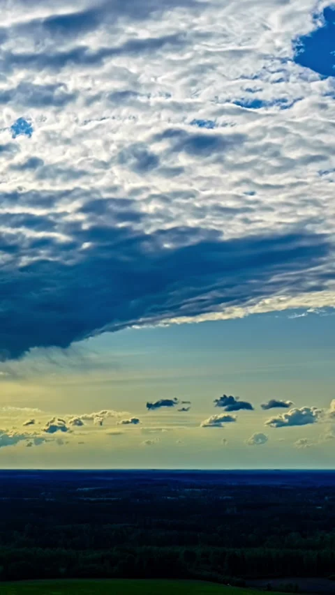 Swirling Cloud Formation Splits Sky at Sunset Aerial Timelapse 스톡 동영상 345117928