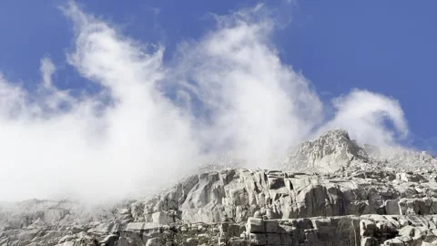 Swirling Clouds Around Steep Granite Cliffs in Alpine Setting Video stock 321158274