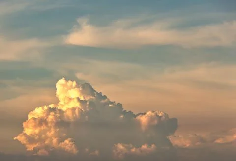 Swirling clouds illuminated by the setting sun Stock Photos