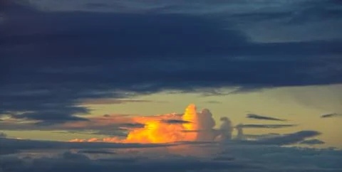 Swirling clouds illuminated by the setting sun Stock Photos