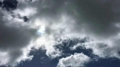 Swirling dark clouds with bright sunlight behind (4K) Stock Footage 61066370