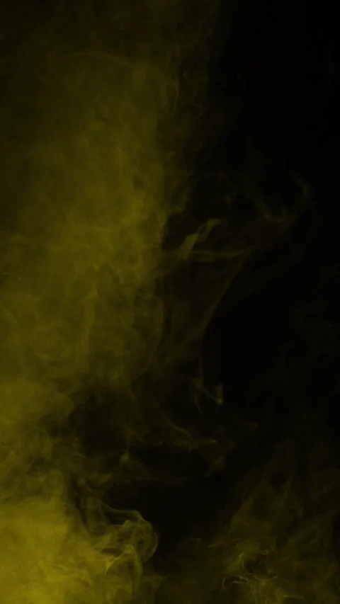 Swirling golden yellow smoke on black background, vertical format Stock Footage 340131553
