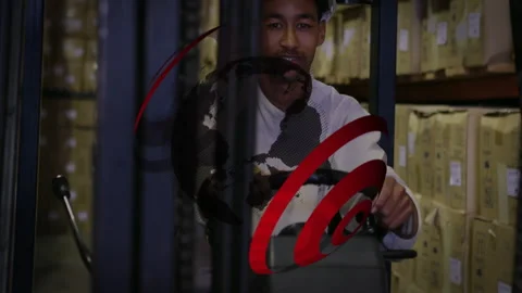 Swirling logo revealing operator steering forklift aisle while donning helmet Stock Footage 310973525