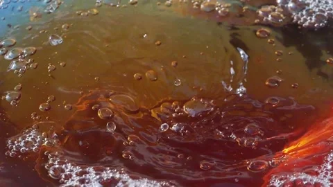 A swirling tea splash with bubbles in slow motion 300fps Stock Footage 287698602