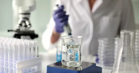 Swirling vortex in beaker during active chemical experiment Stock Footage 312935369