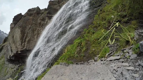 Swirling waterfall from big mountain Stock Footage 118647269