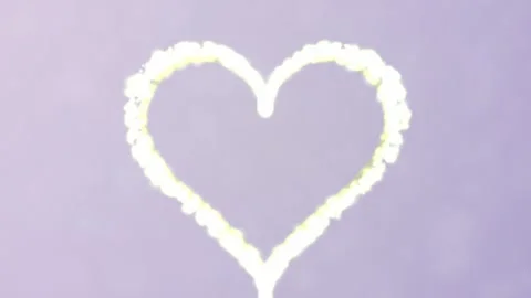 Swirling white smoke forms a dynamic heart shape Stock Footage 327338509