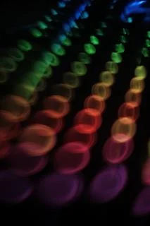   swirly  colorful rounded lights pattern  on black   Stock Photos