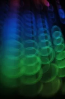   swirly  colorful rounded lights pattern  on black   Stock Photos
