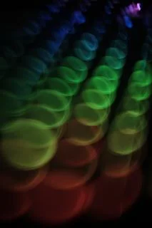   swirly  colorful rounded lights pattern  on black   Stock Photos
